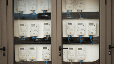 Panel de contadores eléctricos digitales agrupados en una instalación comunitaria.