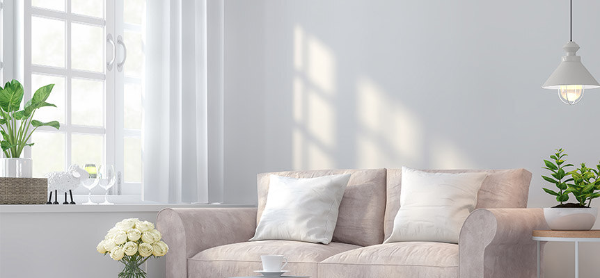Sala de estar luminosa con sofá y ventana