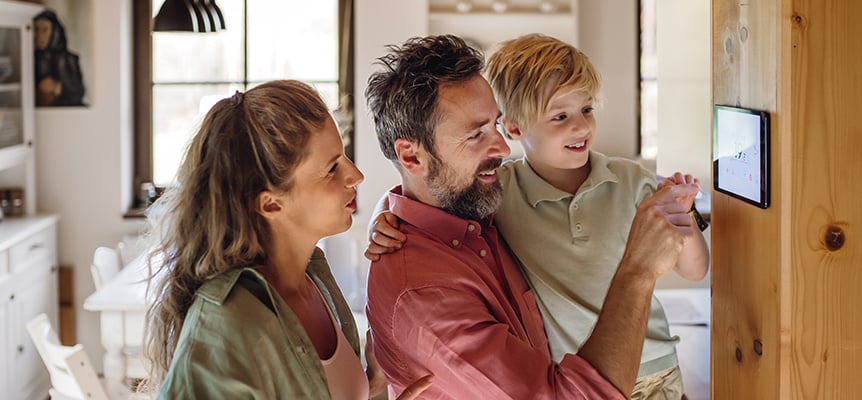 Familia regulando la temperatura de su casa con el termostato